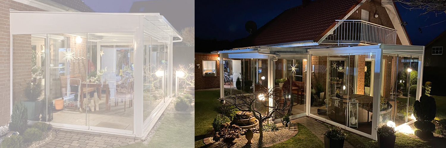 Ansicht eines Hausen in der Nacht mit beleuchtetem Garten und einem Sommergarten mit Glas-Schiebeelementen.